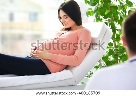 Pregnant woman with doctor at hospital