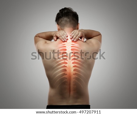 Man with neck pain on grey background