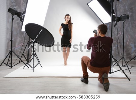 Photographer working with model in studio