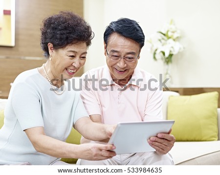 https://thumb7.shutterstock.com/display_pic_with_logo/1371010/533984635/stock-photo-senior-asian-couple-sitting-on-couch-looking-at-tablet-computer-together-happy-and-smiling-533984635.jpg