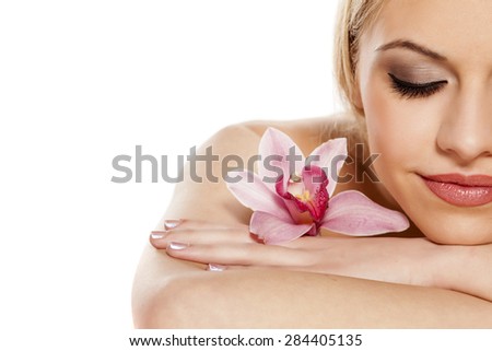 half portrait of a beautiful young woman with orchid