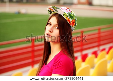 beautiful swag girl posing on the football stadium