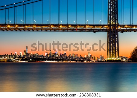 New York skyline at sunset framed by George Washington Bridge