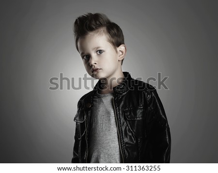 Fashionable child in leather coat.stylish little boy. Autumn fashion.funny 6 years old kid