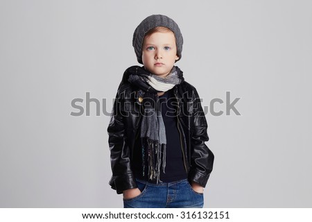 handsome boy in scarf.Funny child in hat.fashionable little boy.stylish kid in leather coat