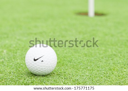 MELBOURNE, AUSTRALIA - JANUARY 18 2014: A Nike golf ball on a green with the hole in the background