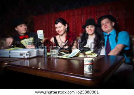 https://thumb7.shutterstock.com/display_pic_with_logo/1427381/625880801/stock-photo-mafia-party-in-restaurant-gangsters-sitting-at-the-table-party-mafia-man-and-woman-share-the-625880801.jpg