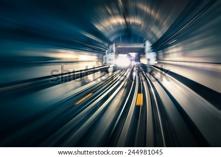 Subway tunnel with blurred light tracks with arriving train in the opposite direction - Concept of modern metro underground transport and connection speed