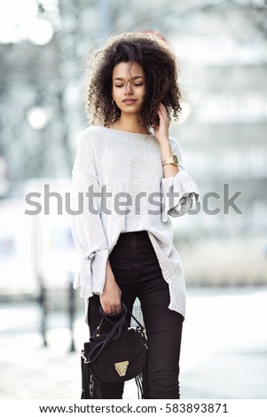https://thumb7.shutterstock.com/display_pic_with_logo/1433129/583893871/stock-photo-street-fashion-portrait-of-young-beautiful-african-american-afro-woman-walking-in-the-city-model-583893871.jpg
