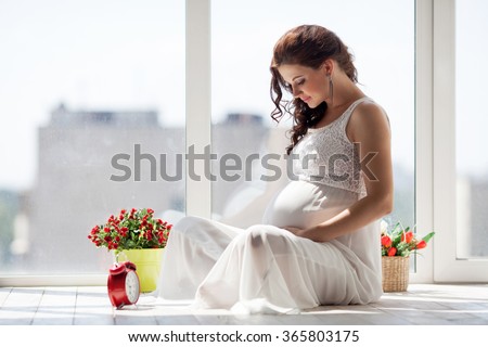 Happy pregnant young woman waiting for a child