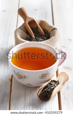 Cup of tea and dried tea leaves