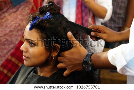 HYDERABAD,INDIA-FEBRUARY 6:Hair stylist or Hair dresser does work on Indian Woman in the beauty salon on February 6,2018 in Hyderabad,India