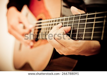 Practicing in playing guitar. Handsome young men playing guitar