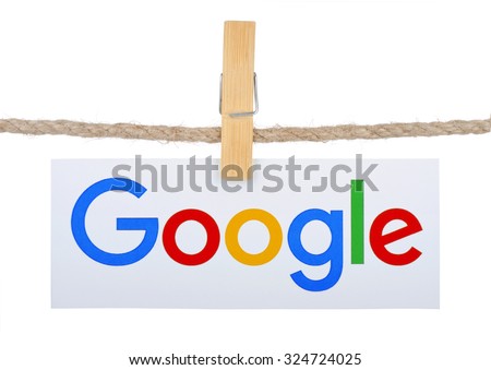 KIEV, UKRAINE - SEPTEMBER 16, 2015: Logo largest Internet search engine Google hanging on the clothesline isolated on white background.Google it is the largest Internet search engine, owned of Google