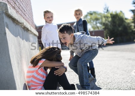 sad moment Elementary Age Bullying in Schoolyard