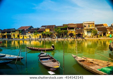 Traditional boats in front of ancient architecture in Hoi An, Vietnam. Hoi An is the World's Cultural heritage site, famous for mixed cultures & architecture.