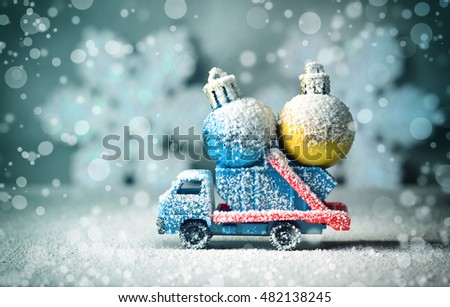 Winter, snow and car with toy. Car carrying a Christmas toy in a snow. Christmas background.