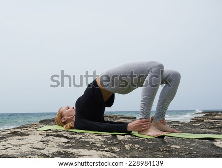 Healthy woman resting and curl up in fetal position outdoor at the sea ...