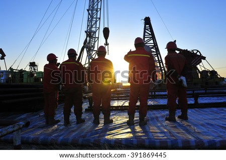 Oil field oil workers at work