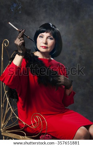 https://thumb7.shutterstock.com/display_pic_with_logo/1545800/357651881/stock-photo-beautiful-retro-woman-in-red-dress-smoking-a-cigarette-on-dark-background-357651881.jpg