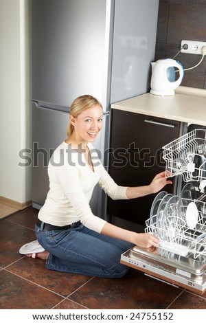 The Blonde Sits Near To Open Dishwasher On Kitchen The Blonde Sits Near To Open Dishwasher On Kitchen