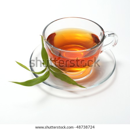 cup with tea and green leaf