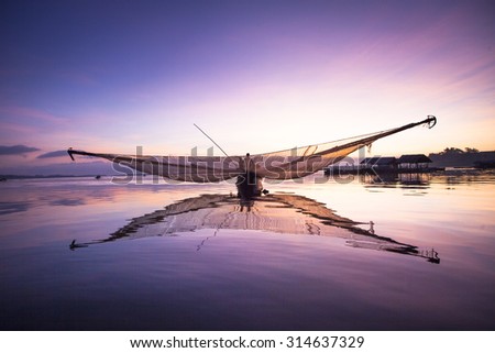TRI AN LAKE, DONG NAI, VIETNAM. May 21, 2013. View of fishing boat's comimg back from night trip in early morning. TRI AN LAKE, DONG NAI, VIETNAM. May 21, 2013