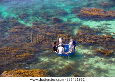 LY SON ISLAND-QUANG NGAI-VIETNAM. APRIL 26,2014. A view of fisher men on round boat in LY SON ISLAND - QUANG NGAI-VIETNAM