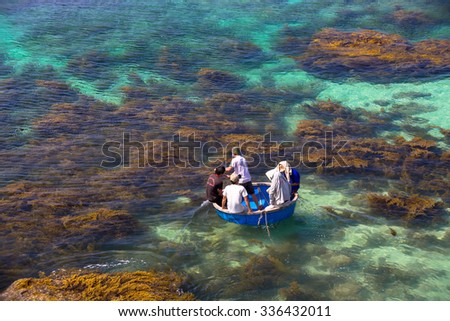 LY SON ISLAND-QUANG NGAI-VIETNAM. APRIL 26,2014. A view of fisher men on round boat in LY SON ISLAND - QUANG NGAI-VIETNAM
