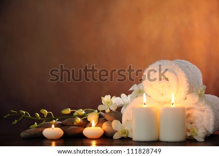 Spa still life with aromatic candles,orchid flower and towel.