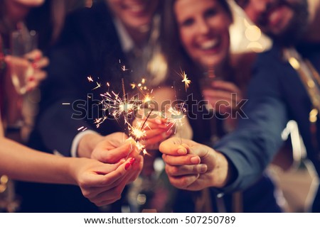 Picture showing group of friends having fun with sparklers