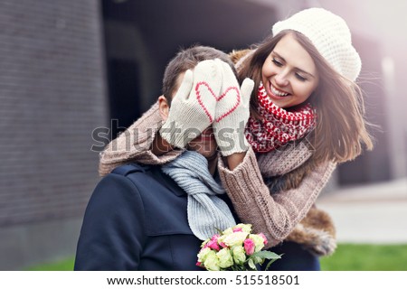 Picture showing young couple with flowers dating in the city