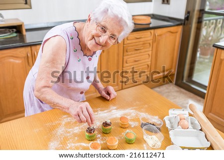 Woman Decorating Cupcakes old woman making decorating cupcakes stock photo 215748847 Woman Decorating Cupcakes old woman making decorating cupcakes stock photo 215748847