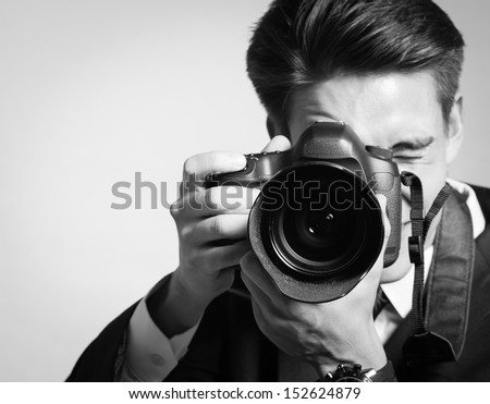 Young man using a professional camera