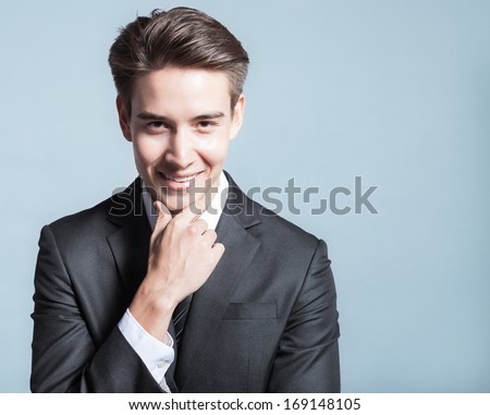Portrait of young happy smiling businessman