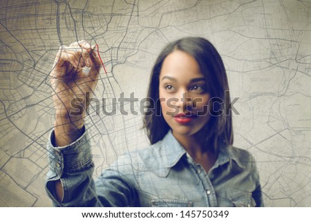 pretty african woman writing on the map
