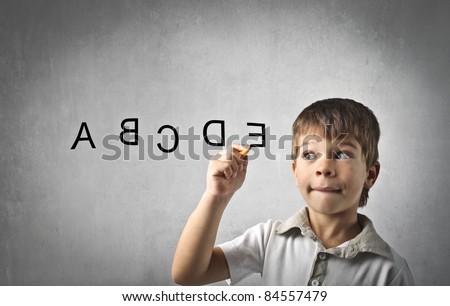 Child writing alphabet letters