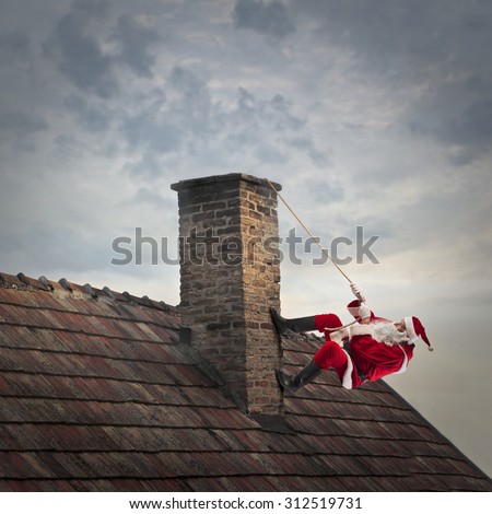 Santa Claus climbing a roof