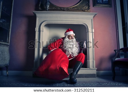Santa Claus popping out of the chimney