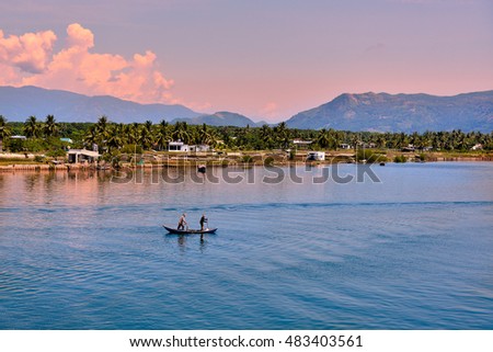 Nha Trang, Vietnam - May 02, 2013: The fisherman and his wife drive the boat to fish in the sea village