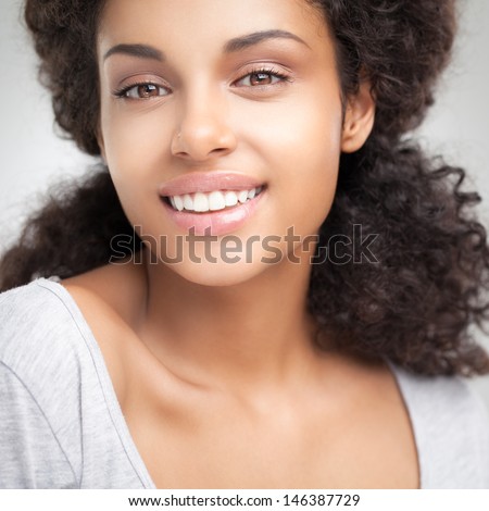 https://thumb7.shutterstock.com/display_pic_with_logo/1615823/146387729/stock-photo-beautiful-smiling-african-woman-posing-against-a-gray-background-146387729.jpg