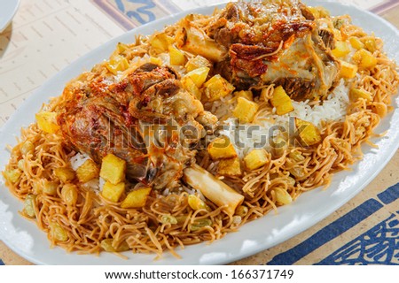 Plate of rice with baked mutton leg. - stock photo