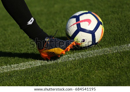 LONDON, ENGLAND - JULY 26, 2017: New Nike Ordem 5 ball. Football player in Puma boots shoots the Official Premier League Ball.
