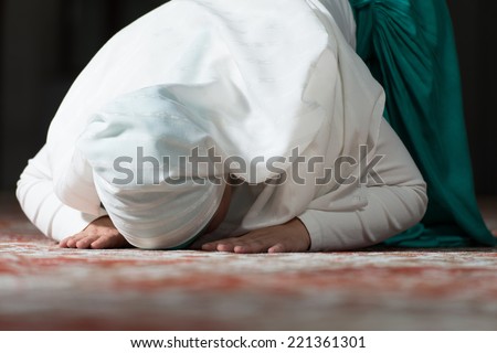 Young Muslim Woman Praying In Mosque - stock photo