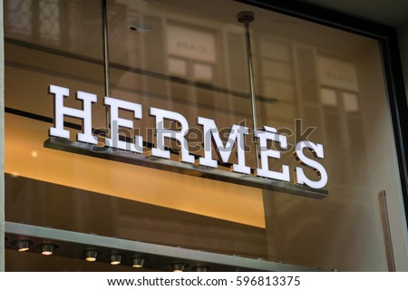 Milan, Italy - February 28, 2017: Shop window of a Hermes shop in Milan - Montenapoleone area, Italy. Few days after Milan Fashion Week. Spring Summer 2017 Collection. Hermes logo