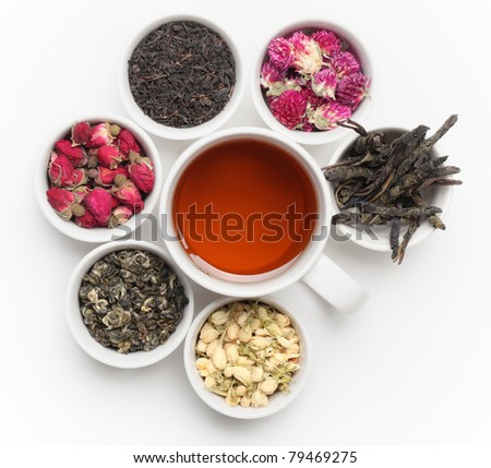 Black Tea in White Cup with tea leaves and flowers.
