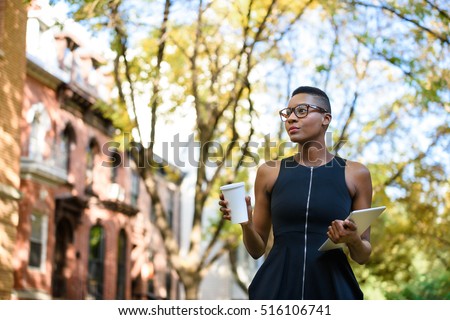 Young african business woman walking down the street