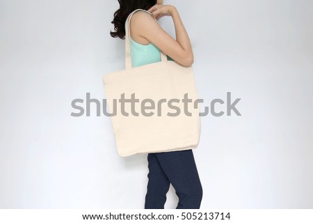 Download Mockup Girl Holding Blank Canvas Tote Stock Photo (Royalty ...