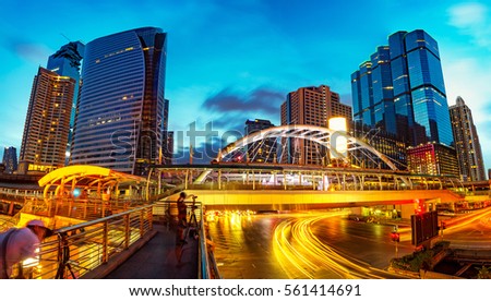 Close view Cityscape Modern building at sunset and cloudy sky.Traffic in the business district The Skytrain station Chong Nonsi,Bangkok,Thailand