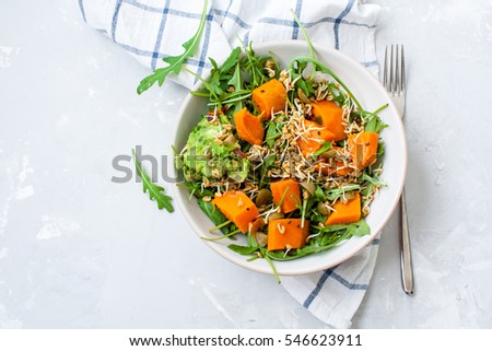 Green salad with sweet potatoes, guacamole and olives. Vegan healthy lunch or dinner. Love for a healthy raw food concept.